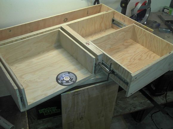 This is the shape I went with.  I used beefy 100lb rails for the drawers.  The back part is sloped to match the back seat angle so it left me with a bit of a void.  I used that area as a large long hidden drawer.