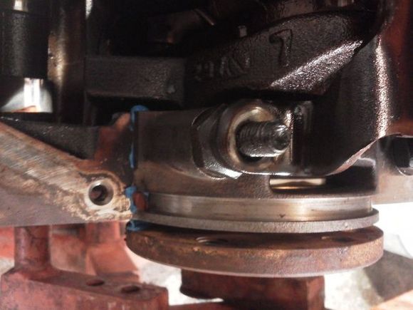 Here is an engine removed from.the jeep and flipped upside down. The oil pan is also removed. This is the far rear of the engine, the rear main cap. The seal is located under there. Is requires that you remove the oil pan and rear main cap. All the rest of the caps must be loosened up. You can then drive the seal out with a punch. If u need detailed instructions let me know.