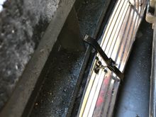 The lower grille uses brackets and screws to hold it in position 