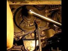 You can use a pry bar or large screw driver to hold the pulley when you are ready to remove the bolt , afterwards the pulley just slides off the crankshaft snout. 