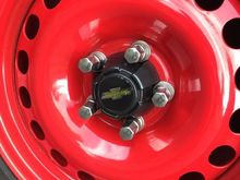 Toyota centre caps with Bow tie centres held on with 3M body side moulding tape. 