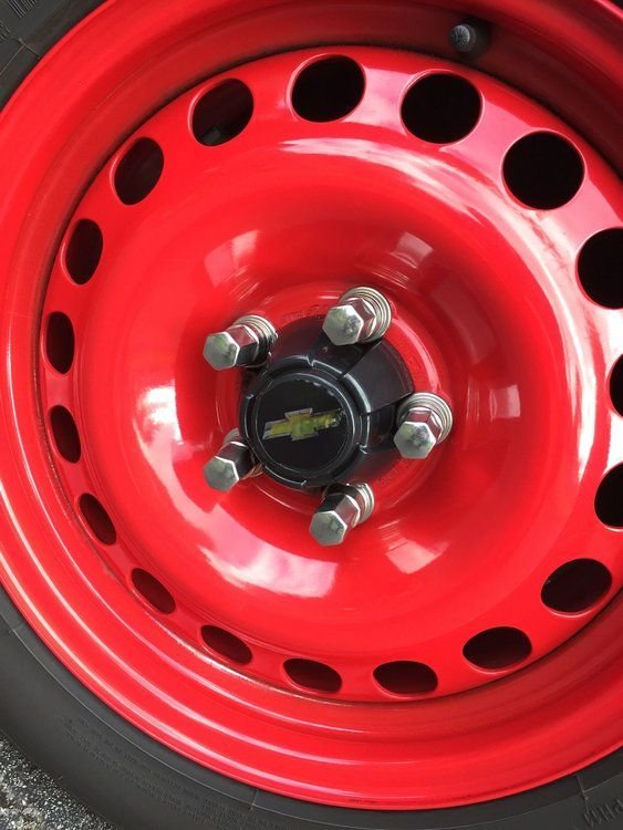 Toyota centre caps with Bow tie centres held on with 3M body side moulding tape. 