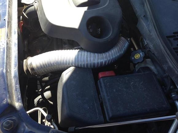 This 3 inch metal dryer vent tube caught fresh air through a shop vac pipe above the radiator. 