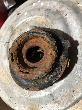 This is the upper spring plate , the bottom side, crusty with rust