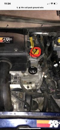 Just down behind the head , below the valve cover