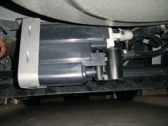 The round canister on the right below the white plastic, the EVAP purge vent valve, P0446 indicates an electrical problem, loose or corroded wires