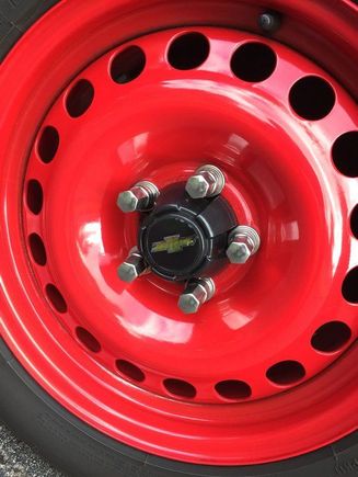 Toyota centre caps with Bow tie centres held on with 3M body side moulding tape. 