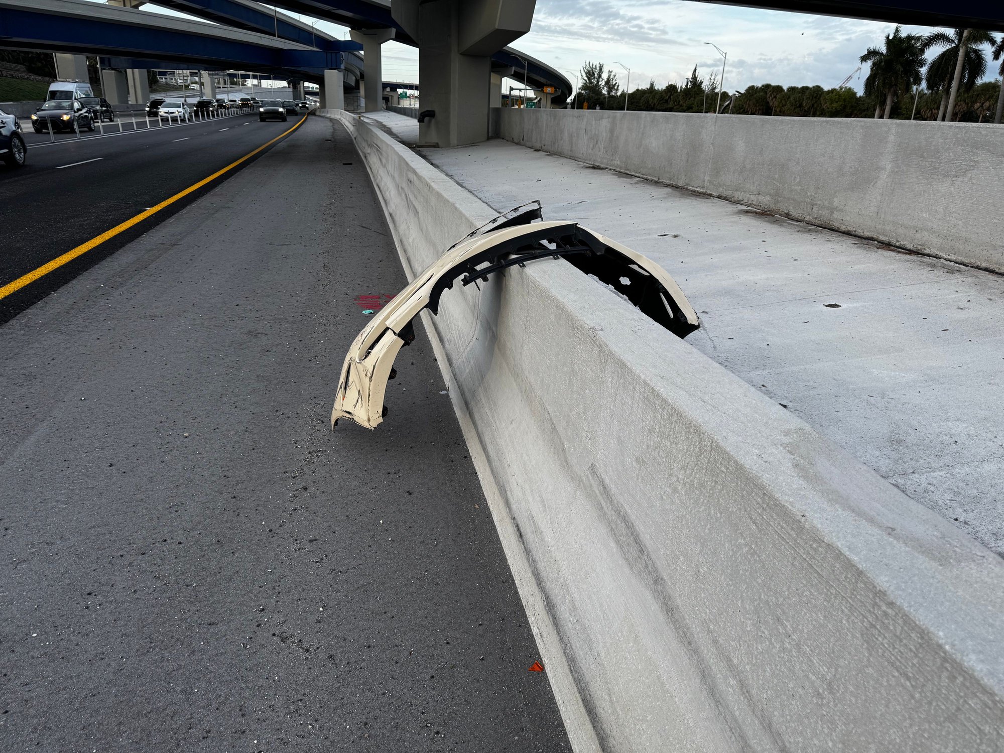 Bumper cover flew off at impact, landed on highway divider 