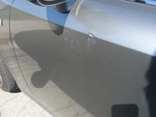 Driver's side door dent with some paint damage
