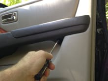 Screw accessible from the underside of the armrest