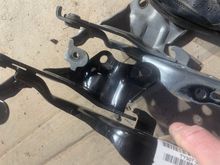 Driver side bracket comparing damaged to new
