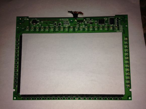 This is the touchscreen PCB. You can see all the Infrared LEDs and sensors. It creates a matrix of beams that are interrupted by your finger and interpreted as position of touch. I confirmed this does have its own microcontroller on it and the serial port for this micro goes to out to the main board processor and also to that mystery connector on the top of the display.