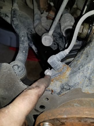 Undo the bolt holding the wheel speed sensor in place.  Thread the bolt back into the hole after you remove the sensor.