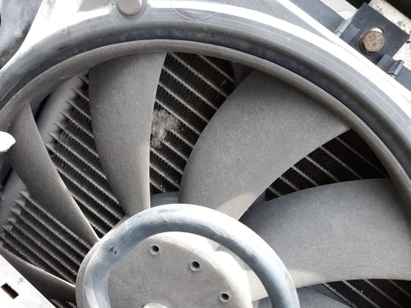 This is an image taken of auxiliary cooling fan in a Mercedes-Benz.
Notice the perimter venturi ring integrated into fan blade assembly...and barely discernible gap between the outer fan blade ring and housing.. More airflow, less power consumption and a lot less noise.