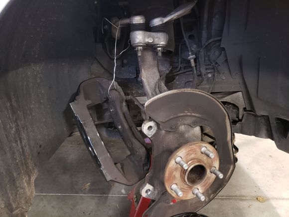 Caliper jig/second hand. Had to tie this up. The Brembo rotor is very heavy and I could not hold both the rotor and caliper at the same time and did not want to risk tearing the flexible rubber brake line.