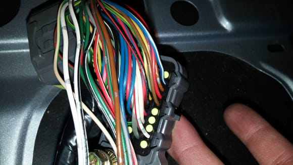 Nice and clear Picture of the 40 Pin ECU connector showing the top right BLUE/WHITE wire moved form pin B66 to B62

Pin B66 is just below the brown wire next to the three yellow caps, Originaly the Blue/White wire was located here (bwlow the brown wire)

Now it is Moved to Pin B62 to work with the ECU correctly