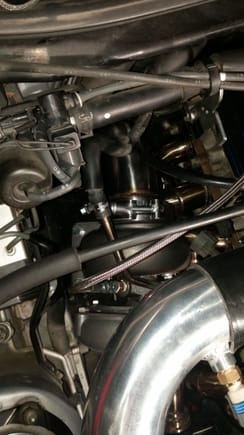 Here is a top shot of the turbo and down pipe near the firewall. This was a very snug fit but also perfect for our cars! the Down Pipe doesn't hit or touch anything once everything is tightened up. ALSO in this picture you can get an idea of where the bolt is that I had to modify to get the turbo bolted down.. you can see the one rear bolt in the picture but the one directly across from it near the cylinder head is the one that needed cut as stated from the previous post