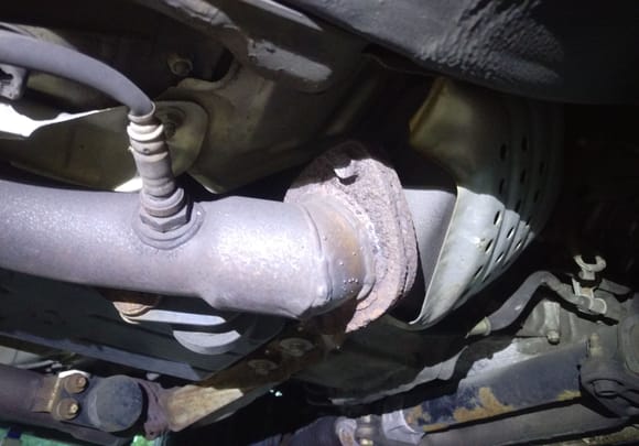 The broken gasket is on the right at the junction just after the catalytic converter there, notice the oxygen sensor immediately after it