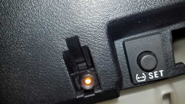 What is this orange light/button, near TPMS reset button? (Pic) What is this orange light/button, near TPMS reset button? (Pic)