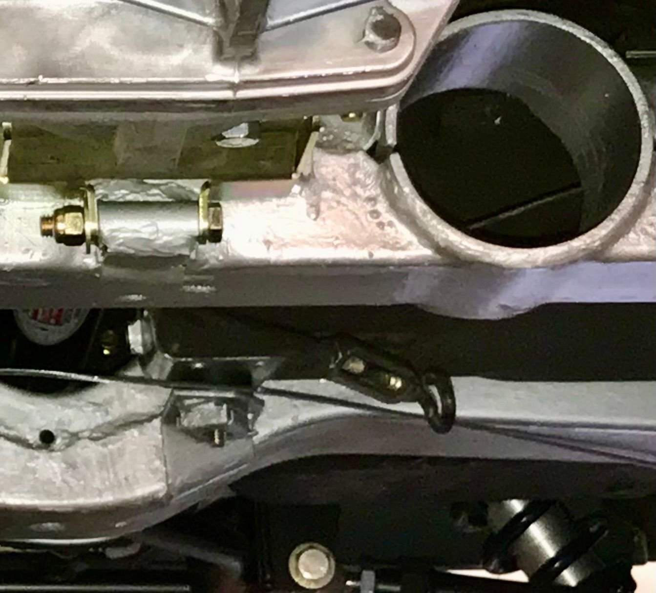This is the inner body mount on the driver side on my ‘64 coupe. The bracket on the frame utilizes a caged nut the to secure the bolt from the interior. It passes through an L-shaped bracket riveted to the floor of the body. The vertical part of the L-shaped bracket is threaded and accepts the seatbelt shoulder bolts. Body mount #3 performs the same function for the outer belt.