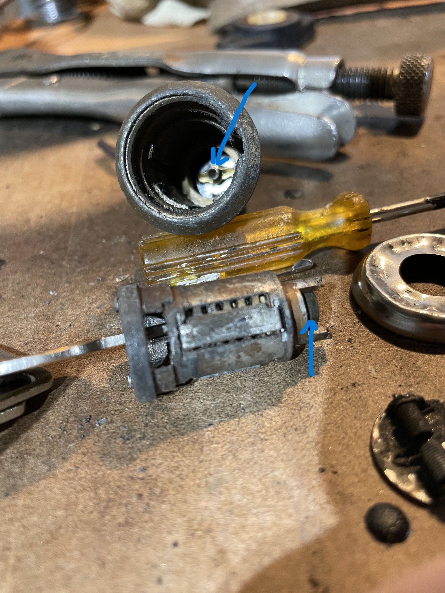 Put key in cylinder and had to gentle pry the cylinder out (dirt and grease).  Note spring at bottom of body and round pad at bottom of cylinder