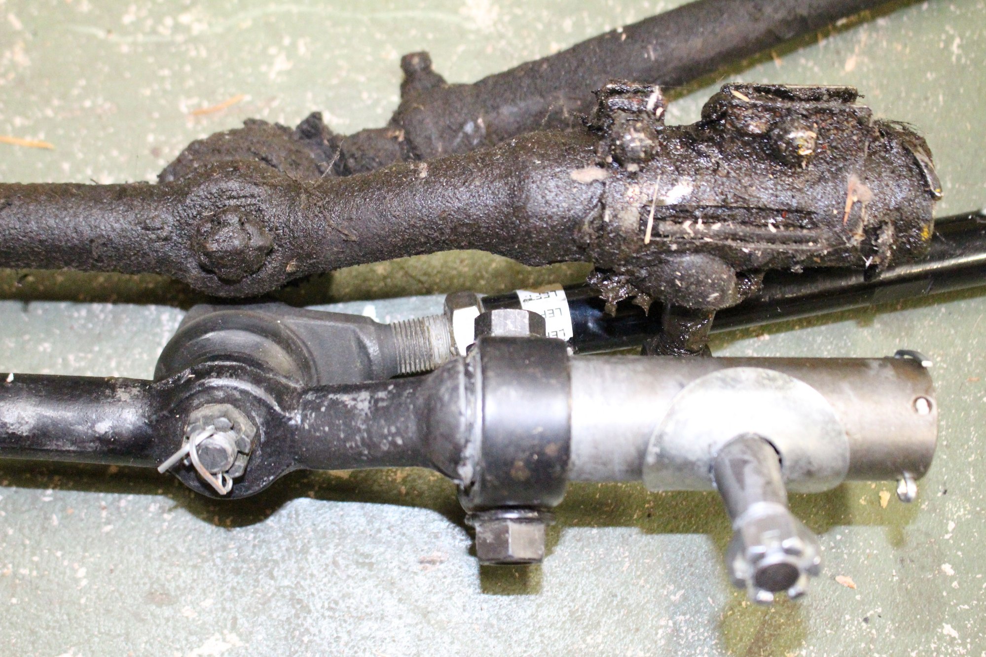 MS centerlink above. PS centerlink below, with Borgeson adapter on it. I swear the pitman arm stud does not look like it lines up with the upper one. A different distance to the the tie rod joint.