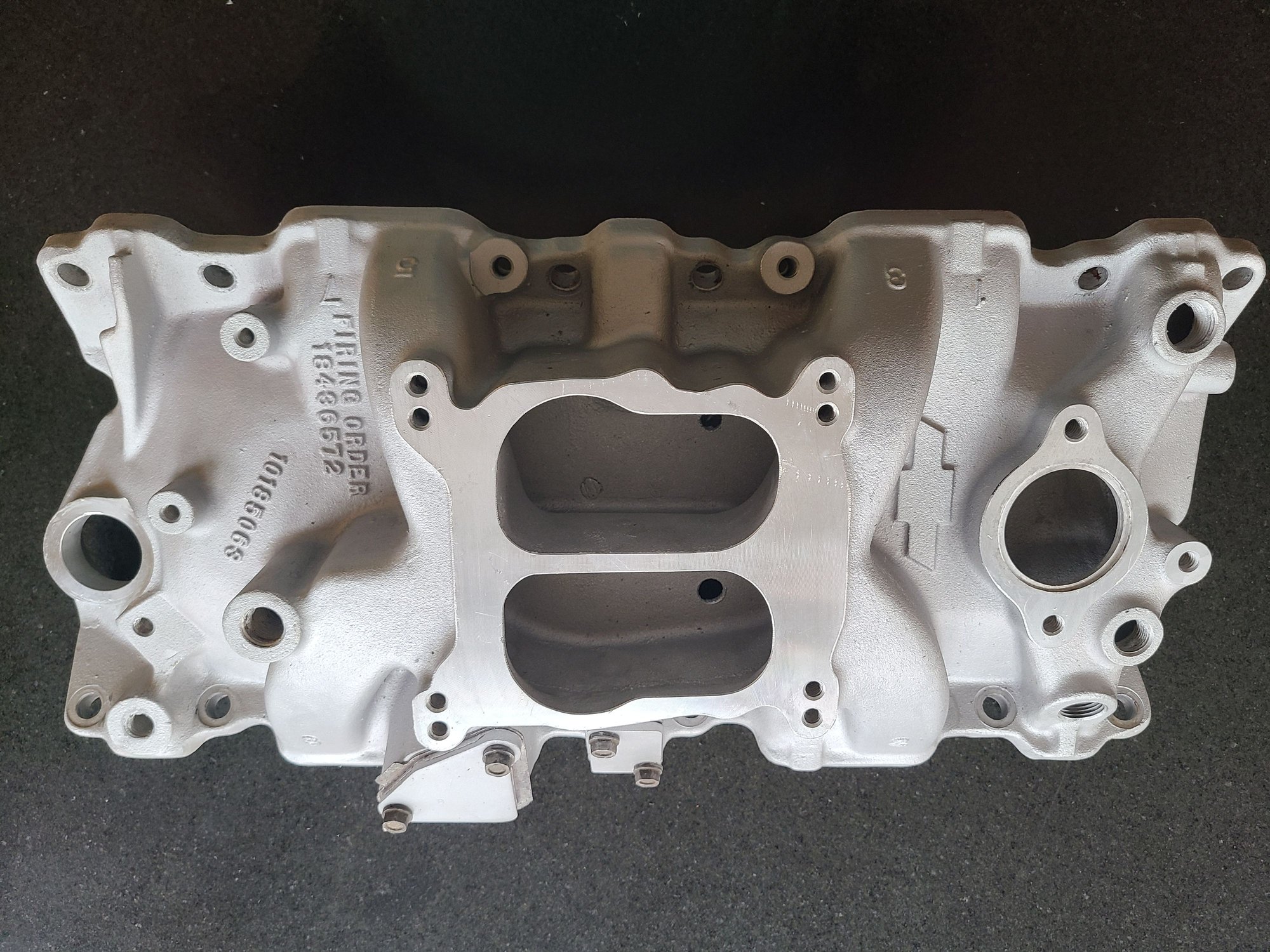 10185063 is the casting number.  It fits under my 80 hood with the stock air cleaner and cold air intake.