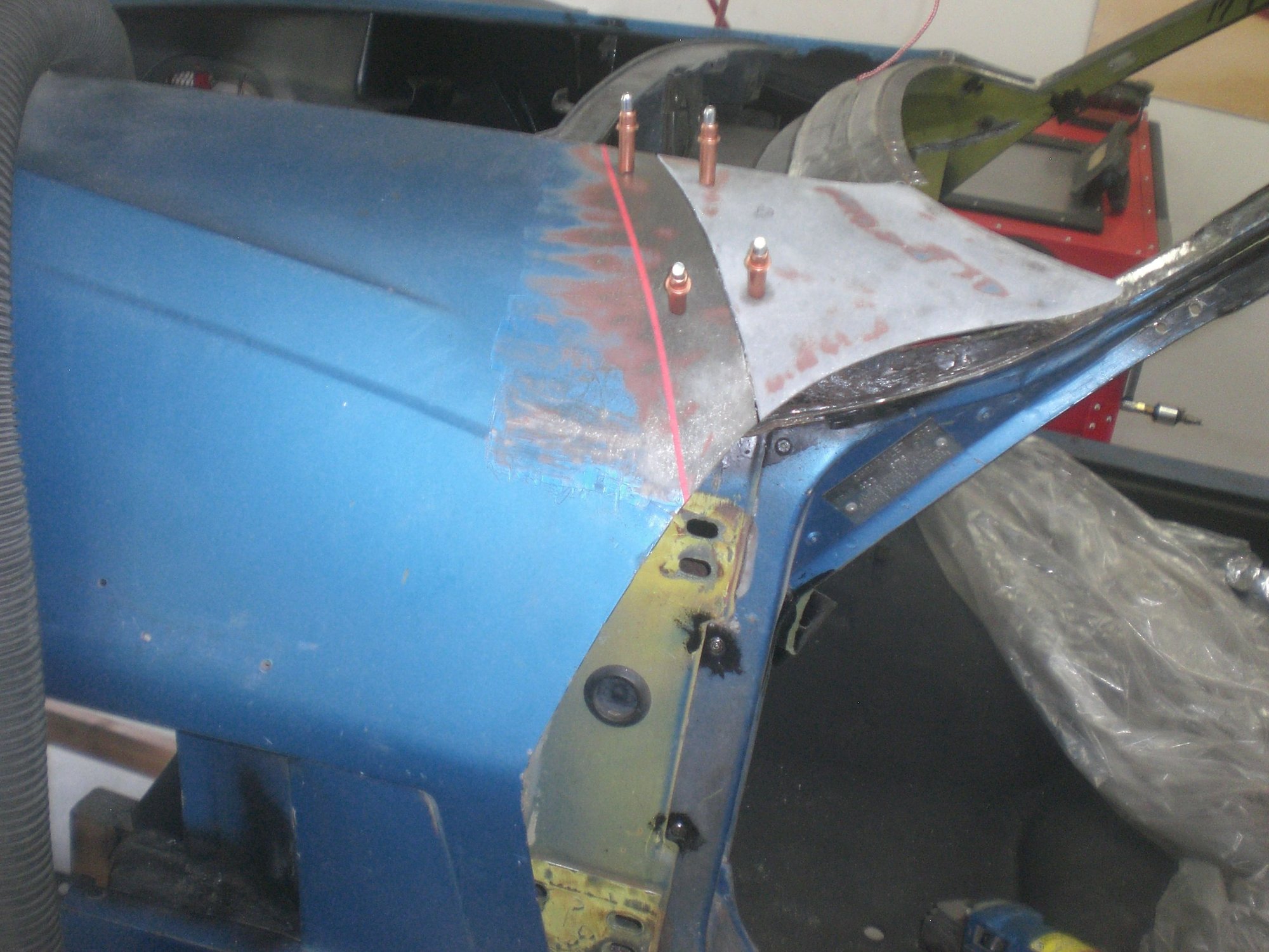 This shows were the fender cut was made.  After viewing the underlying support assembly, I wish I would have made the cut closer to where the red line is.  That wouldve given me better access to the lower forward edge of the metal outer corner where it goes across and down the hinge pillar.