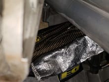 The carbon fiber looking hose wrap is lava sleeve from Summit Racing good for 1200* continuous contact and 2000* intermitent.  I actually have more than an inch of clearance on all the sleeves from the header.