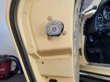 If it's a slot does it go side to side? 
Does anyone have a picture  of a undamaged door?
What does the stock hardware look like, just a bolt and washer?