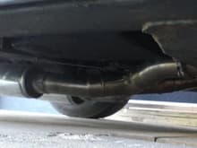 x-pipe mounted between transmission and rear end