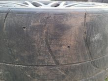 Front driver tire has plenty of tread left (hole wear indicators).