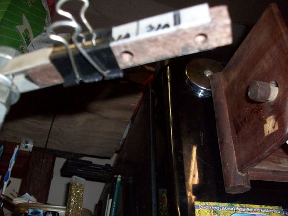 Sliding end of caster guage (square with threaded rod) to measure difference between upper and lower ball joint centers - and calculate caster.