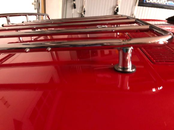 You may be able to lower the rack by cutting the chrome stand offs a little.