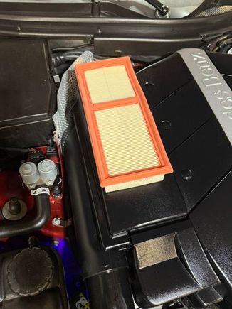OEM filter on top of the larger air filter chamber.  The difference is dramatic.  I had already installed the new filter and didn't want to take it out for comparison, but you get the idea.
