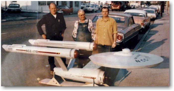 The production crew with the original filming model of the Enterprise.