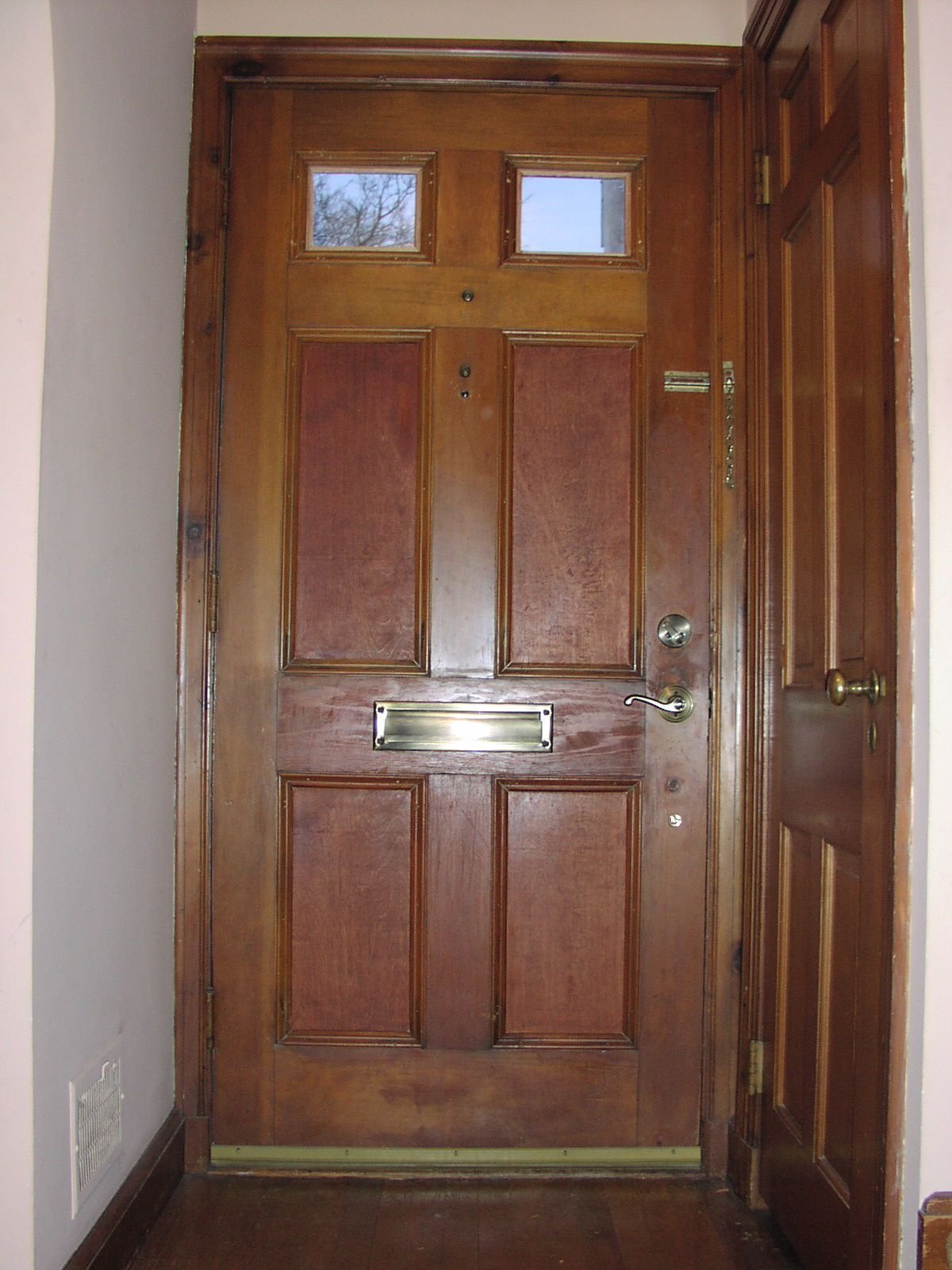 Exterior wood door shrinks and expands with season