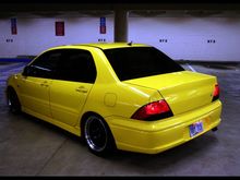 Guys this is what I want my Lancer to look like, at least from this angle. I'm sure this one has and aftermarket front bumber from this angle I'm loving the view. No spoiler, no loud exhaust, and remove the lancer es words from the trunk. Just keep it simple neat and clean. Aftermarket rims? Of course a must. But that's it for the outside. Everything else keep it looking stock. Even the lights keep it stock. I'll keep my car black and tint windows :) oh and lowering springs? Yes lol.