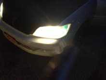 My stock headlights with green parking light