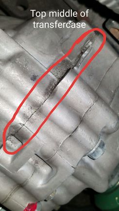 Some sort of wet residue on top middle of transfercase