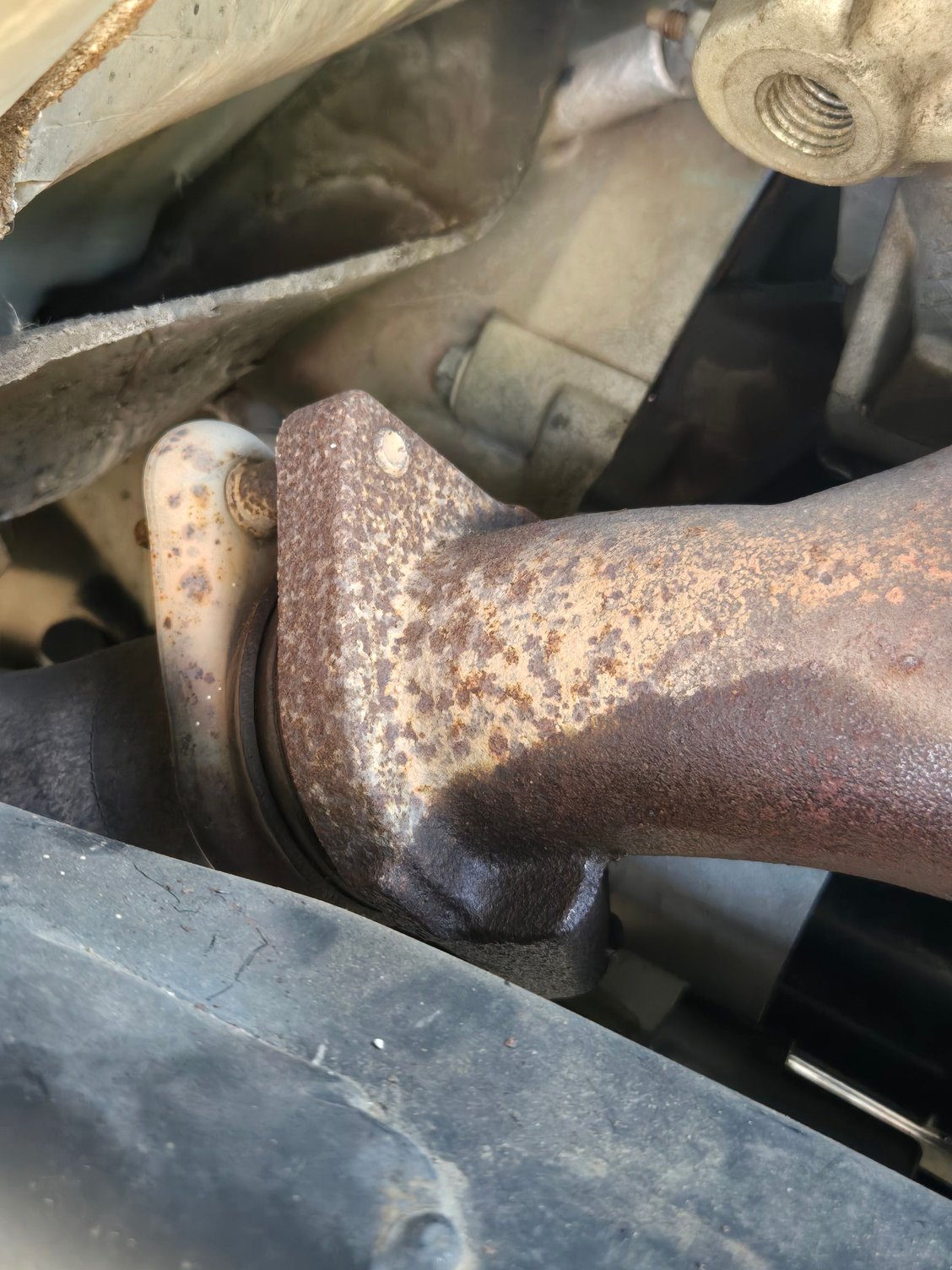 I believe these 2 exhaust downpipe bolts are the only thing holding the cylinder head down since the 10 head bolts are removed (as well as phaser)