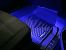 I mounted blue LED strips under the front seats and tied them to the cargo lights.