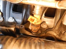 picture of #7 fuel injector and #8 spark plug hole. See Gap in intake manifold just to the right of the #8 spark plug hole.
