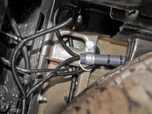 Weatherproof conduit protects cables running from front passenger door sill to rear of truck.
