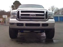 front view showing Superlift dual steering stabilizers and black Ford Emblem