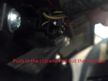 On the back of the top of the benzel, remove the Wire Harness for the Passenger Airbag Notification. 

Press In on the Clip and Pull Out.