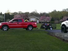 Dad's new 13 f150 stx 5.0, loaded up the quads for a cancer benefit run. My old truck 05 fx4 sitting in the driveway.