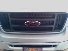 Front grill with metallic red on glossy black overlay
