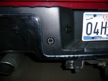 Camera mounted in space to left of license plate.  The bumper already had a hole there, so I just drilled the trim piece.