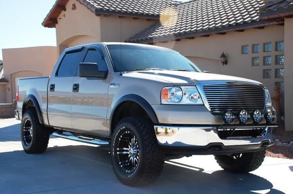 2008 Ford F150 XLT Crewcab 4X4: Modifications include 2&quot; Daystar Leveling System, 33-inch BFG All Terrain KOs mounted on 18-inch Eagle Series 197 Wheels, Aftermarket Flares, Edge Evolution Programmer, Flowmaster SS Dual Exit Exhaust, K&amp;N Cold Air Intake, Randy Ellis Light Bar with (4) PIAA Lights, Roush Grille, Chrome Sidesteps, Bedliner, Window Visors, and Full 20% Tinted Windows.